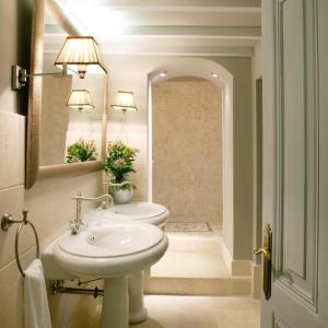 a bathroom with a sink and a toilet and a mirror at Hotel Castillo de Arteaga in Gautegiz Arteaga