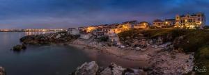 a group of houses on the shore of a body of water at Baleal Sol Alojamentos in Baleal