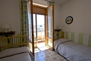 Postel nebo postele na pokoji v ubytování Affittacamere La Casa Di Elide