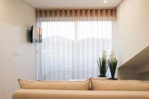 a living room with a couch and a window at Braga Center Apartments - Rua do Alcaide in Braga
