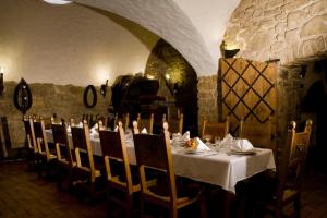 a dining room with a white table and chairs at Hotel Zámeček Pod Hradem Starý Jičín 111 in Starý Jičín