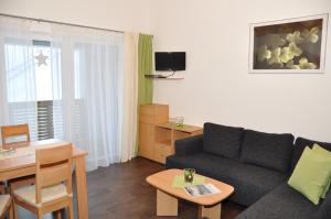 a living room with a couch and a table at Appartements Montana in Vent