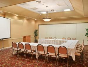 a large meeting room with a white table and chairs at Quality Inn in Vincennes
