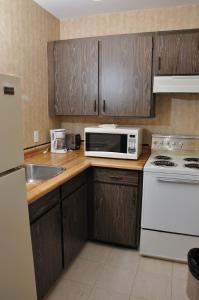 a kitchen with a white microwave and a sink at Linda Vista Motel in Surrey