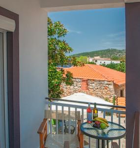 a balcony with a table with fruit on it at Evmorfias House in Kallirakhi