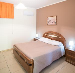 a bedroom with a large bed and two night stands at Il Castagneto in Campagna
