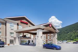 un hôtel avec une voiture garée sur un parking dans l'établissement Ramada by Wyndham Creston, à Creston