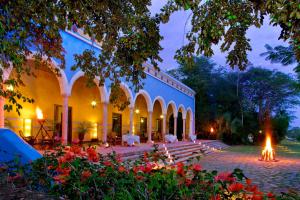 a building with a courtyard with flowers in front of it at Hacienda Santa Rosa in Santa Rosa