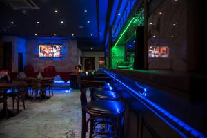 Hotel Elegance NV في باراماريبو: بار بأضواء زرقاء وخضراء في مطعم