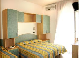 Postel nebo postele na pokoji v ubytování Hotel Garden