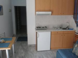 a kitchen with a sink and a counter top at Limani Apartments in Plakias