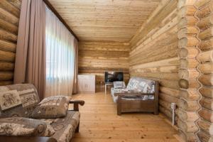 a living room with wooden walls and wooden floors at Aquamarine Resort in Akshi