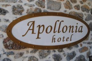 a sign for a hotel on a stone wall at Apollonia Hotel in Masouri