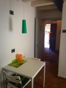a white table and chairs in a room with a green light at B&B El Piastrol in Bagolino