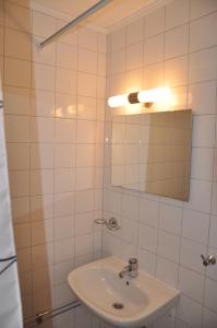 a white bathroom with a sink and a mirror at Spånhults Herrgård Hostel in Norrahammar +10 photos