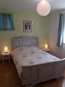 a bedroom with a large bed with two lamps at Gite Mentrel in Champ-le-Duc
