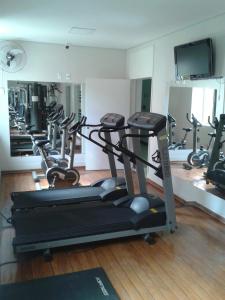 a gym with a bunch of treadms and machines at Botucatu Hotel in Botucatu