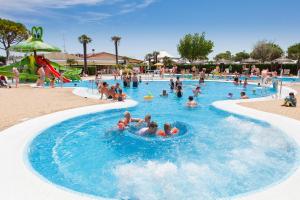 a group of people in a swimming pool at a resort at Vela Blu Camping Village in Cavallino-Treporti