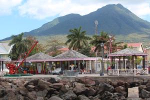 a resort with a playground and a mountain in the background at Villa Benito in Nevis