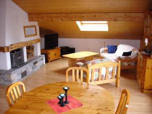 a living room with a table and chairs and a living room at Chalet Sunneschyn in Schwanden