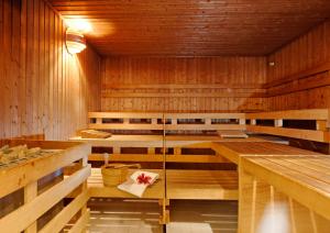 a sauna with wooden walls and wooden floors at Hotel Carat in Erfurt