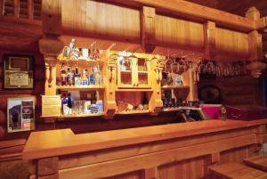 a bar with a lot of bottles and glasses at Honor Pensiune & Spa in Izvoare