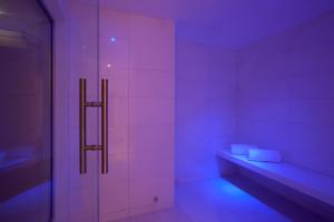 a purple room with a bench and a shelf at Sandy Beach Hotel & Spa - ex Sentido in Larnaca