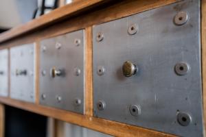 un grupo de paneles metálicos sobre una mesa de madera en Les Appart'confort, en Bain-de-Bretagne