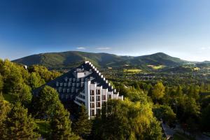 uma vista aérea de um edifício com montanhas ao fundo em Hotel Jaskółka em Ustroń