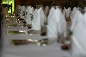 a long table with wine glasses and wine bottles at Klasztor Cedynia Hotel in Cedynia