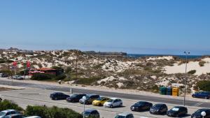 a parking lot with cars parked on the side of a highway at Star inn Peniche in Peniche