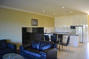 a living room filled with furniture and a kitchen at Yarrawonga Mulwala Golf Club in Yarrawonga