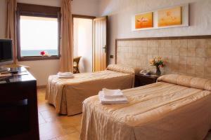 Postel nebo postele na pokoji v ubytování Hotel Antonio