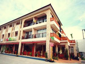 a large building with balconies and plants on it at The Orchid House - SHA Extra Plus in Kata Beach