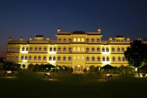 a large building lit up at night at Grand Uniara A Heritage Hotel in Jaipur
