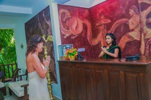 a woman in a wedding dress standing in front of a counter at Jungle Villa in Induruwa