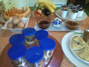 a table topped with bowls of fruit and other food at B&B Casacasina in Monzambano