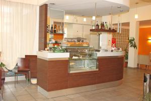 a restaurant with a counter with a display in a room at Hotel Bed&Business in San Giovanni Teatino
