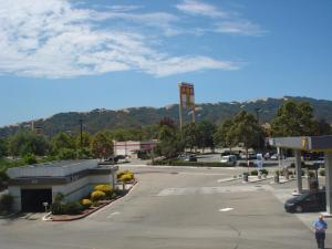 a parking lot of a gas station with a mountain at Garlic Farm Inn in Gilroy