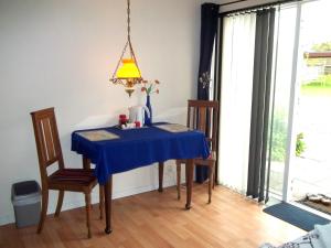 a table with a blue table cloth on it in a room at Bed and Breakfast Vester Hjermitslev in Saltum