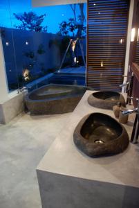 a bathroom with three sinks with a large window at Villa Sassy in Seminyak