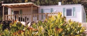 a small white house with a fence in front of it at La Canardiere in Casta