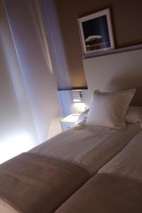 Postel nebo postele na pokoji v ubytování Hotel Nagusi