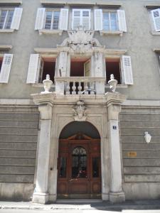トリエステにあるPalazzo Brigidoの木製のドアが目の前にある建物