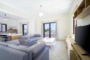 a living room with two couches and a tv at Seaside Villa Balos in Kissamos