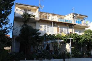 a large white building with balconies and trees at Apartments Miriam Srima in Vodice