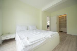 ティミショアラにあるGaga Residence 14の白いベッドルーム(白いシーツを使用した大型ベッド1台付)