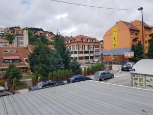 a parking lot with cars parked on top of a roof at Apartman Galerija in Užice