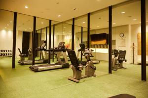 a gym with several exercise equipment in a room at Metropolo, Hangzhou, East Railway Station in Hangzhou