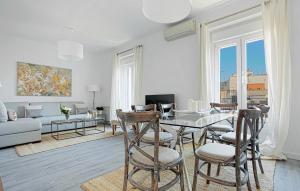 a white living room with a table and chairs at Genteel Home Reina Sofía in Madrid
